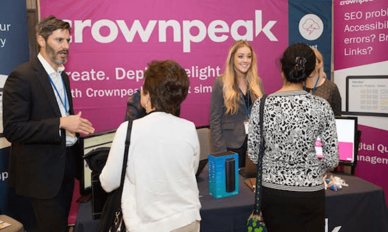 People talking at a tradeshow booth